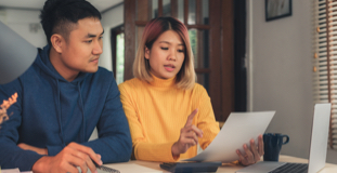Couple reviewing tax documents and discussing filing bankruptcy